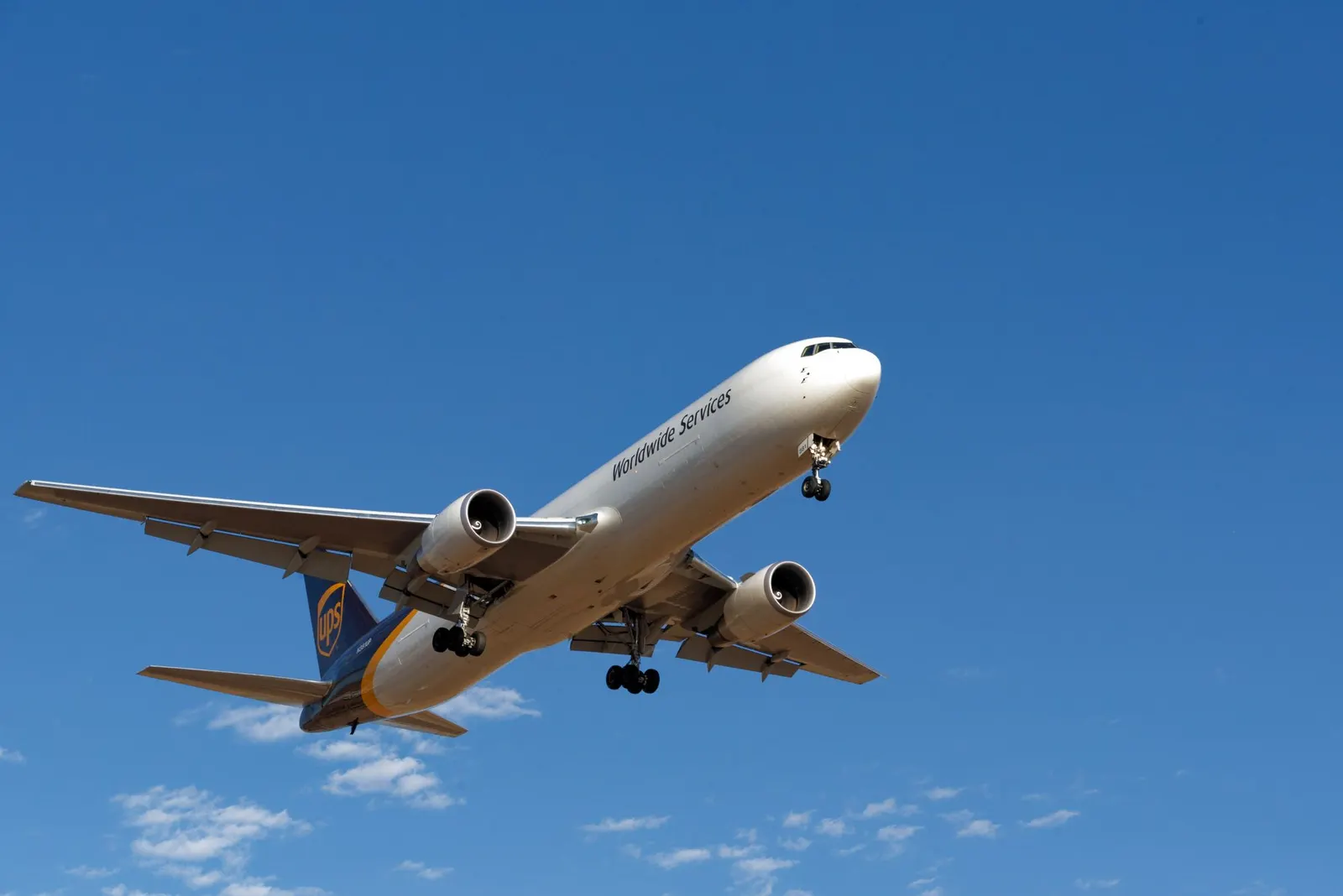 Cargo aircraft climbing against a clear blue sky